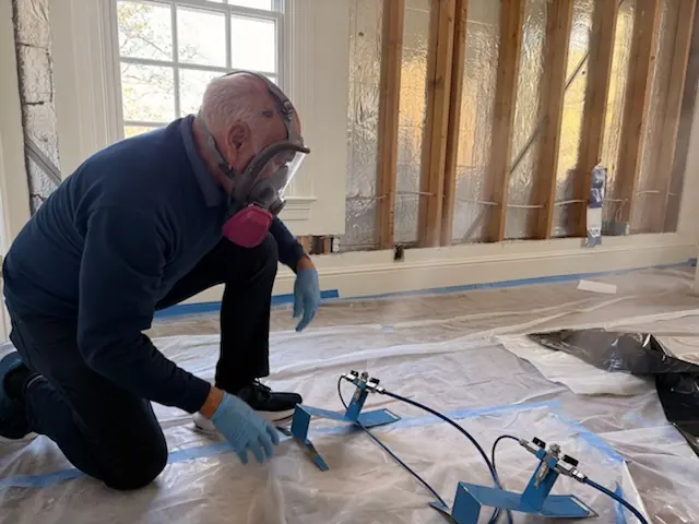 A restoration technician setting drying equipment in an Beaumont home stripped to the studs
